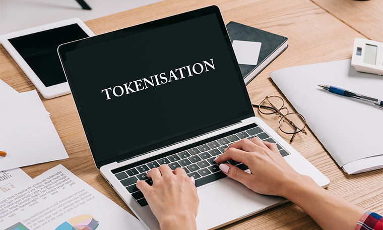 Partial view of businesswoman using laptop with Tokenisation on screen