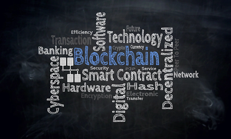 Blockchain word cloud written on a black board.
